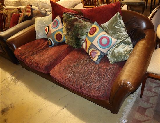 A brown leather Chesterfield two seater settee, with fabric upholstered cushion seats, W.200cm